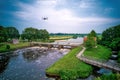 An aerial view with drone in the background above a weir in the river Vecht in the Netherlands. Downstream