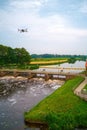 An aerial view with drone in the background above a weir in the river Vecht in the Netherlands. Downstream