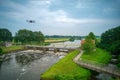 An aerial view with drone in the background above a weir in the river Vecht in the Netherlands. Downstream