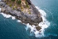 Aerial view Drone camera top down of seashore rocks in a blue ocean Turquoise sea surface Amazing sea waves crashing on rocks Royalty Free Stock Photo