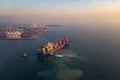 Aerial view from drone, Cargo vessel in beautiful scenic sky.