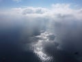 Aerial view. The drone flies over foggy and fluffy clouds. Blue sky sun and sea fog. Abstract aerial nature summer ocean Royalty Free Stock Photo