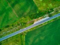 Aerial view from drone flight over different agricultural fields and the road on diagonal