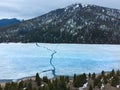 Aerial View from a Drone Flying above Frozen Lake Cracked Ice Mountains Royalty Free Stock Photo