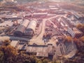 Aerial view from drone of industrial area with warehouses, buildings, trucks, industry equipment, heavy transport