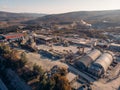 Aerial view from drone of industrial area with warehouses, buildings, trucks, industry equipment, heavy transport