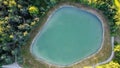 Aerial view of a little lake and trees surrounding, in italian Appennini hills Royalty Free Stock Photo