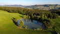 Aerial view of a little lake and trees surrounding, in italian Appennini hills Royalty Free Stock Photo