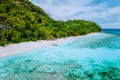 A aerial view from a drone of sandy beach with palm trees and lonely tourist boat in blues clear lagoon on Therese Royalty Free Stock Photo