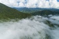 Aerial view drone shot of flowing fog waves on mountain tropical rainforest,Bird eye view image over the clouds Amazing nature Royalty Free Stock Photo