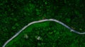 Aerial view or drone shot of the road with car through the green forest in Asia. Royalty Free Stock Photo