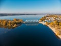 Aerial view drone shot of steel railroad bridge crossing big blue river, train transportation Royalty Free Stock Photo