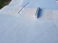 Aerial view with drone of a skatepark near the sea. Sloped metal rails for grind tricks