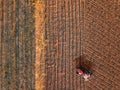 Aerial view from a drone of a tractor while tillage and ploughing in a farm land field. Top view for agriculture concept Royalty Free Stock Photo