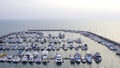 Aerial View by Drone of Yacht Club and Marina. Top view of yacht club. White boats in sea water. Marina dock yachts and Royalty Free Stock Photo