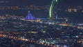 Aerial view of Dubai city skyline at night with illuminated burj al arab hotel timelapse. Royalty Free Stock Photo