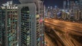 Aerial view of Dubai marina and JLT skyscrapers with glowing windows night timelapse with traffic on sheikh zayed road. Royalty Free Stock Photo