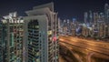 Aerial view of Dubai marina and JLT skyscrapers with glowing windows night timelapse with traffic on sheikh zayed road. Royalty Free Stock Photo