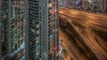 Aerial view of Dubai marina and JLT skyscrapers with glowing windows night timelapse with traffic on sheikh zayed road. Royalty Free Stock Photo