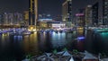 Aerial view of Dubai Marina with shopping mall, restaurants, towers and yachts night timelapse, United Arab Emirates.