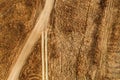 Aerial view of dusty dirt road through grassy plain landscape