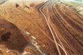 Aerial view of dusty dirt road in plain landscape Royalty Free Stock Photo