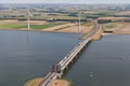 Aerial view Dutch landscape with bridge and wind turbines