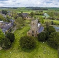 An aerial view east over the church and village of Chipping Warden, UK