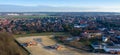 Aerial view of the edge of a growing village, followed by a new development area under construction.