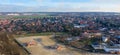 Aerial view of the edge of a growing village, followed by a new development area under construction