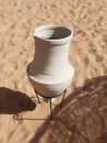 Aerial view of Egyptian pot on sand. Old white pottery on the beach Royalty Free Stock Photo