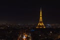 Aerial view of the Eiffel Tower and the rooftops of Paris during a gorgeous night. France