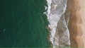 Aerial view of an emerald green sea and big foaming waves. Dikwella beach.