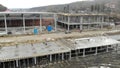 Aerial view of Employees go and work for a large construction midnite.