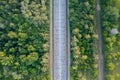 Aerial view of a of an empty abandoned road in the forest. Beautiful landscape with empty rural road. Top view from flying drone