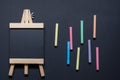 Aerial view of an empty blackboard shaped like an easel on a black background