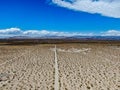 Aerial view of empty dirt road in the arid desert.