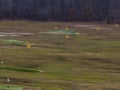 Aerial view of an empty golf driving range with dry grass on a cloudy day Royalty Free Stock Photo