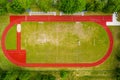 Aerial view of empty green football field and red running tracks Royalty Free Stock Photo