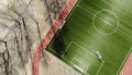 Aerial view of empty green football field with trees and their shadow Royalty Free Stock Photo