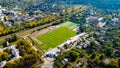 Aerial view of an empty soccer football field in town with railway