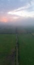 Aerial View of Enchanting Summer Landscape: Foggy Country Road at Sunrise Royalty Free Stock Photo