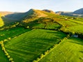 Aerial view of endless lush pastures and farmlands of Ireland. Beautiful Irish countryside with emerald green fields and meadows. Royalty Free Stock Photo