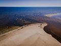 Aerial view of Engure beach in Latvia. River meets Baltic sea. Lonely man on the shore. Royalty Free Stock Photo