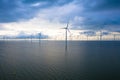 Aerial view, Enormous windmills stand in the sea along a dutch sea.