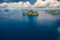 Aerial view the Entalula Island from the distance. Open ocean, white clouds at high altitude. Bacuit Bay, El Nido Royalty Free Stock Photo