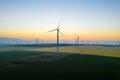 Aerial view of Eolian generators in a beautiful wheat field. Eolian turbine farm. Wind turbine silhouette. Wind mill turbines. Wi