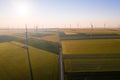 Aerial view of Eolian generators in a beautiful wheat field. Eolian turbine farm. Wind turbine silhouette. Wind mill turbines. Win Royalty Free Stock Photo