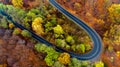 Aerial view of European road, beautiful serpentine curvy road with autumn colors