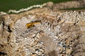 Aerial view of excavator working in a limestone quarry